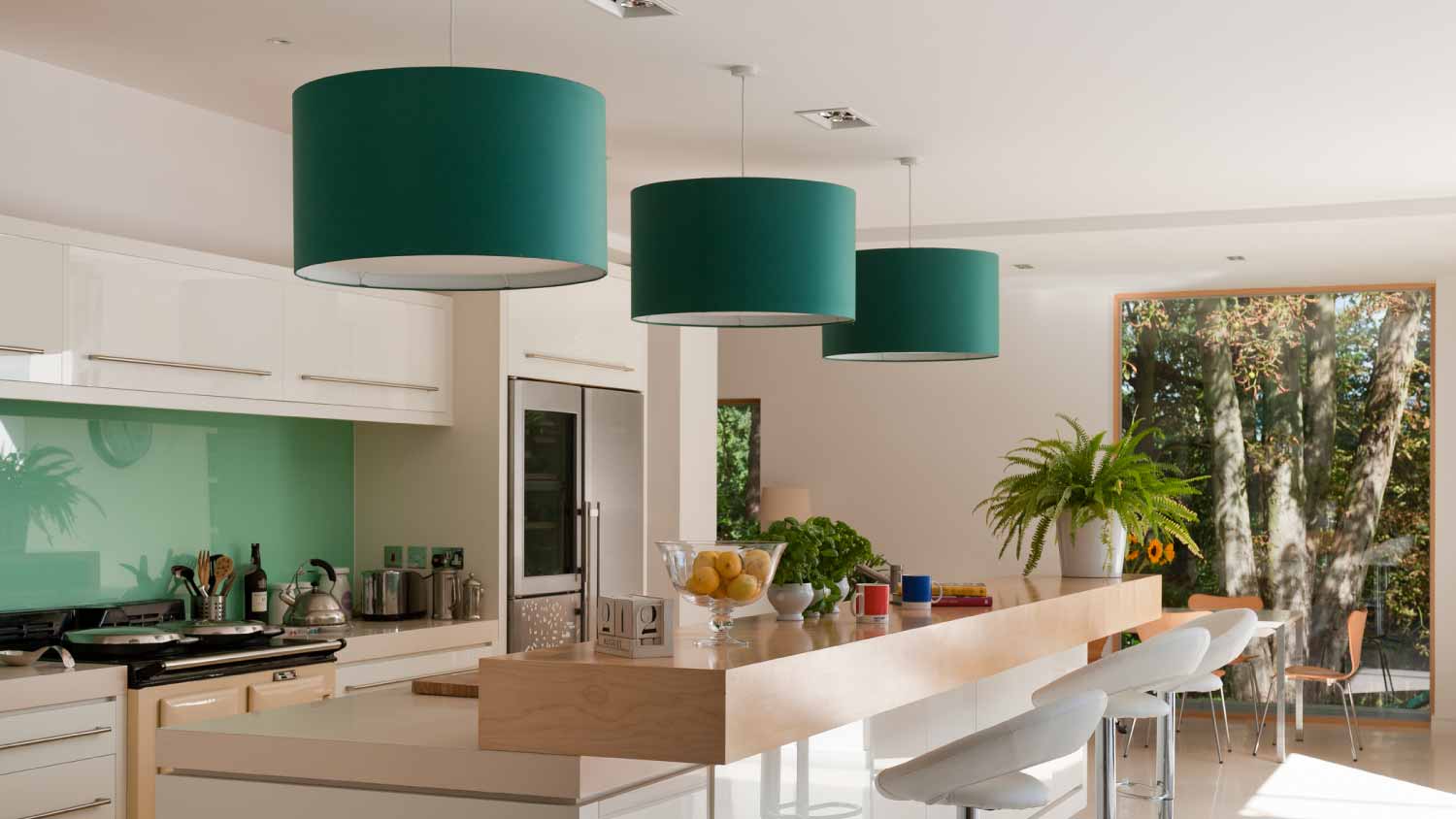Kitchen with three green pendant lights