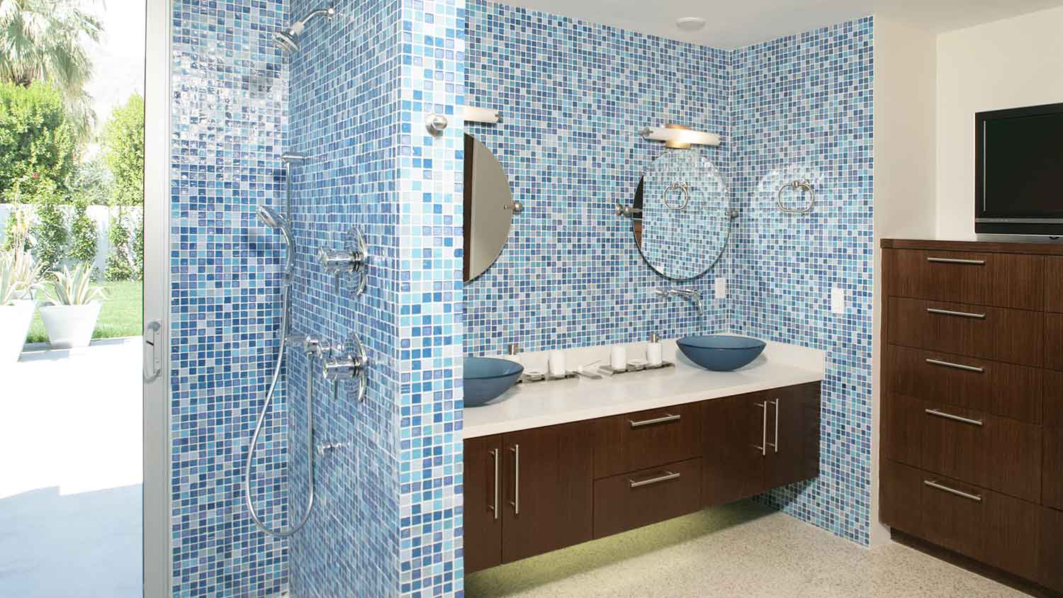 Large bathroom with blue mosaic tile on the walls