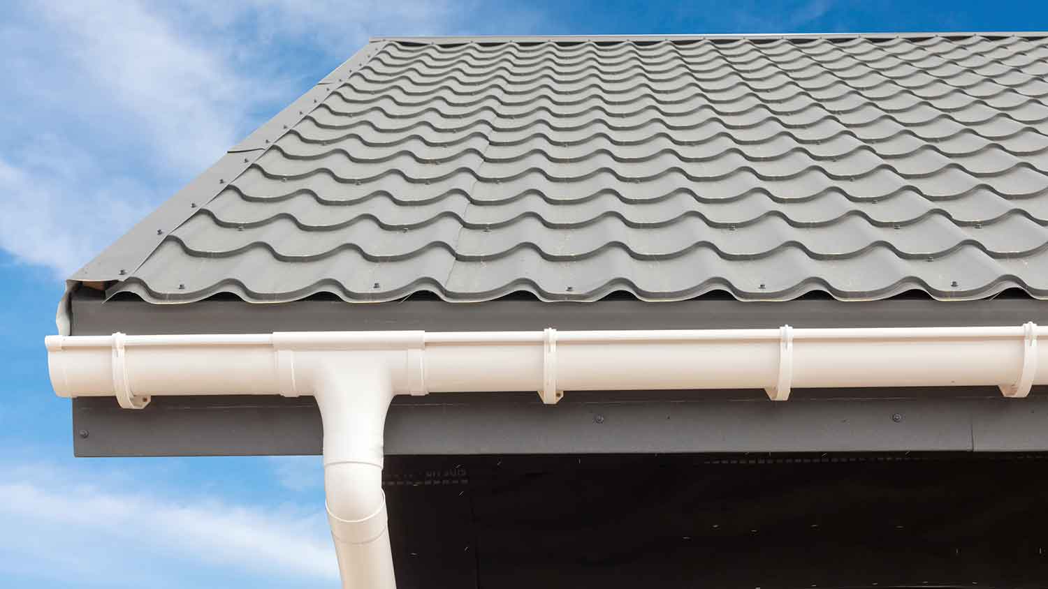 Gutter hangers installed on a vinyl rain gutter