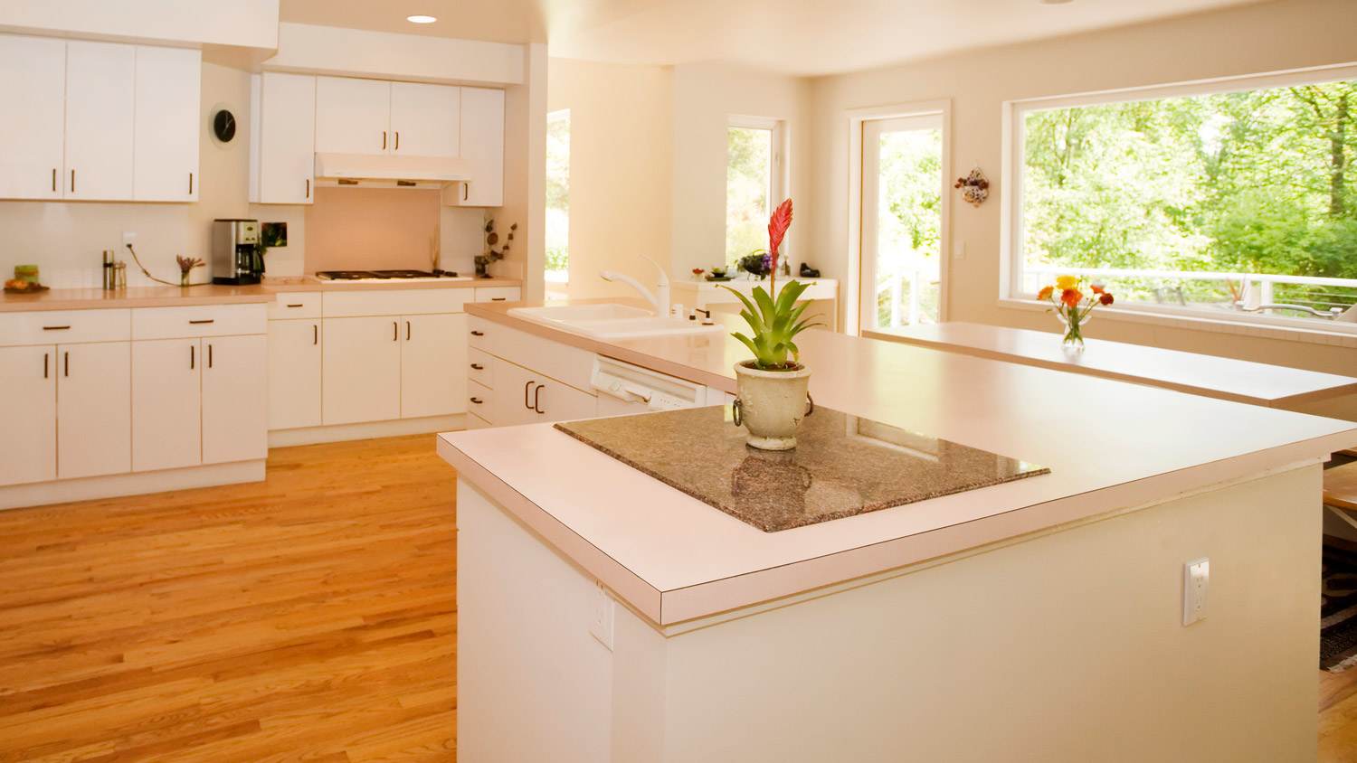 Bright and clean kitchen with large right angle island