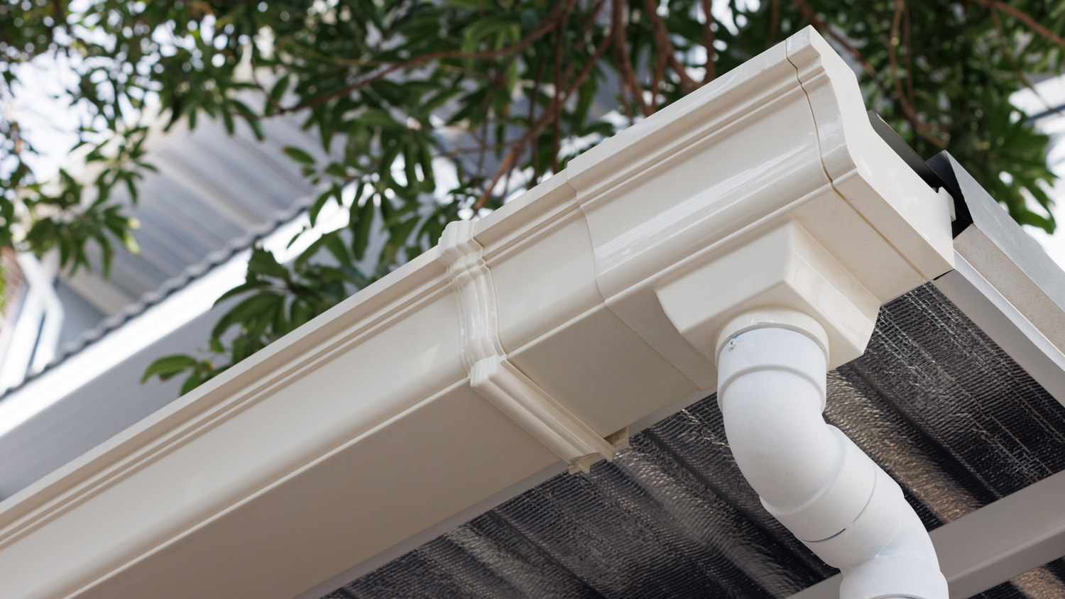 White vinyl gutter on house
