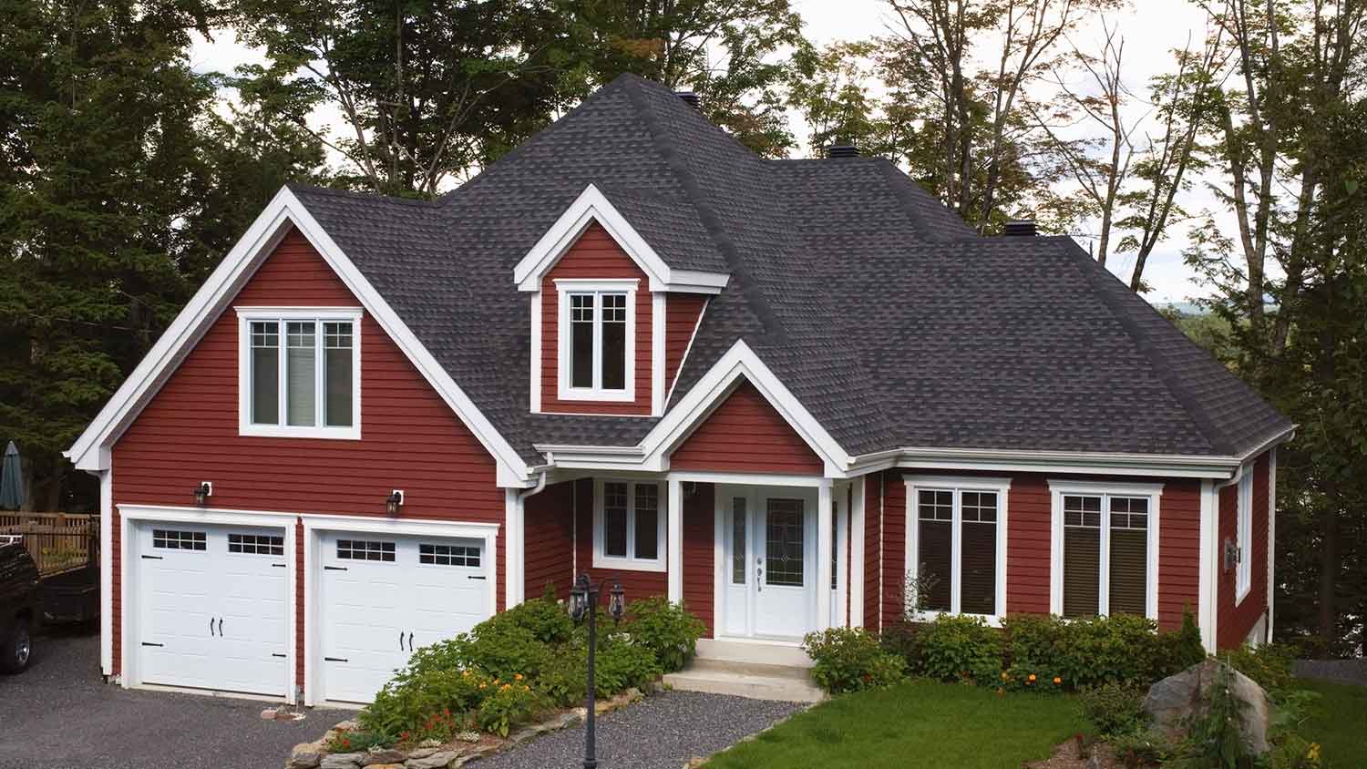 Large country house with autumn red siding