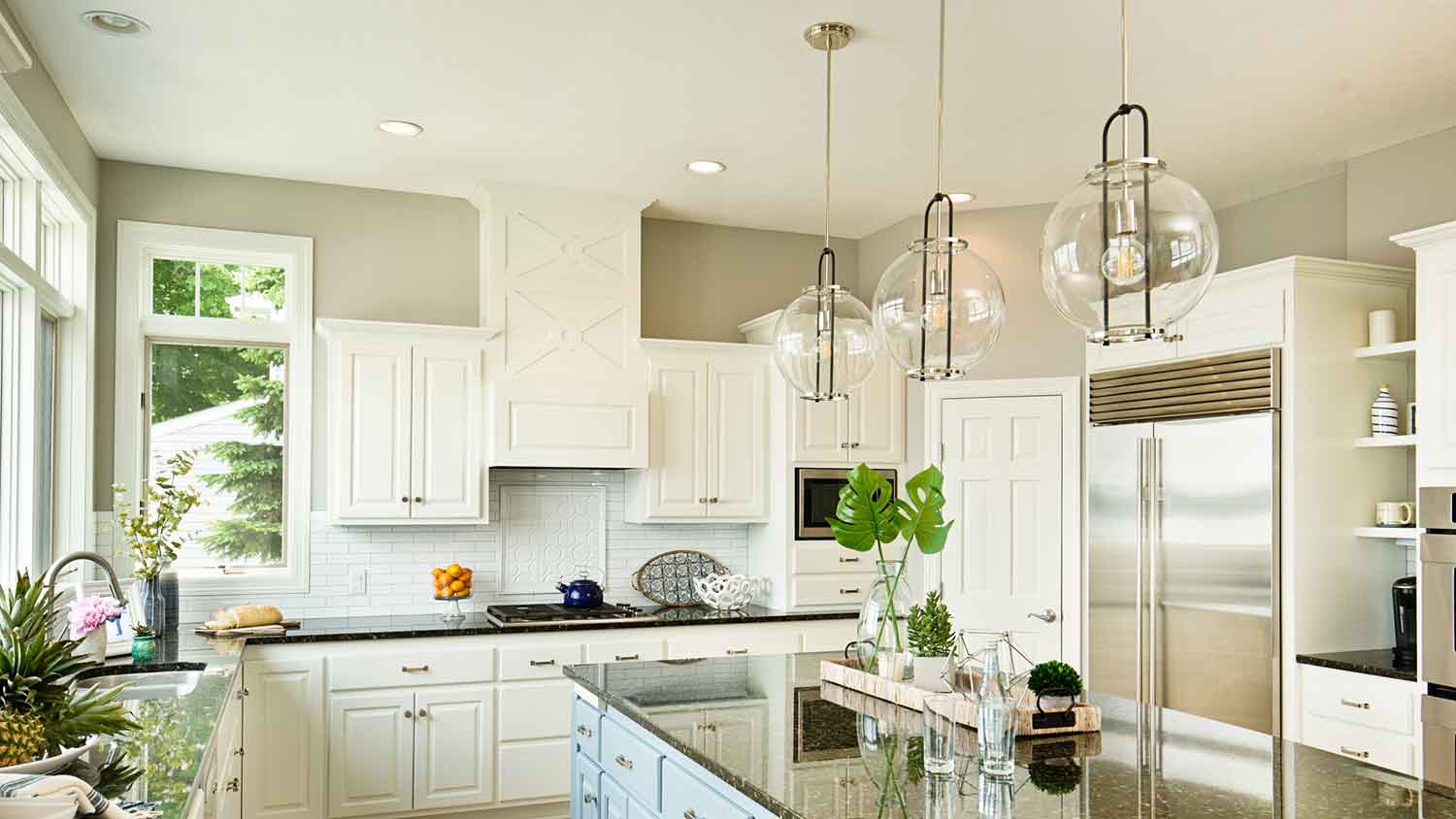 Clear glass lighting fixtures over the kitchen island