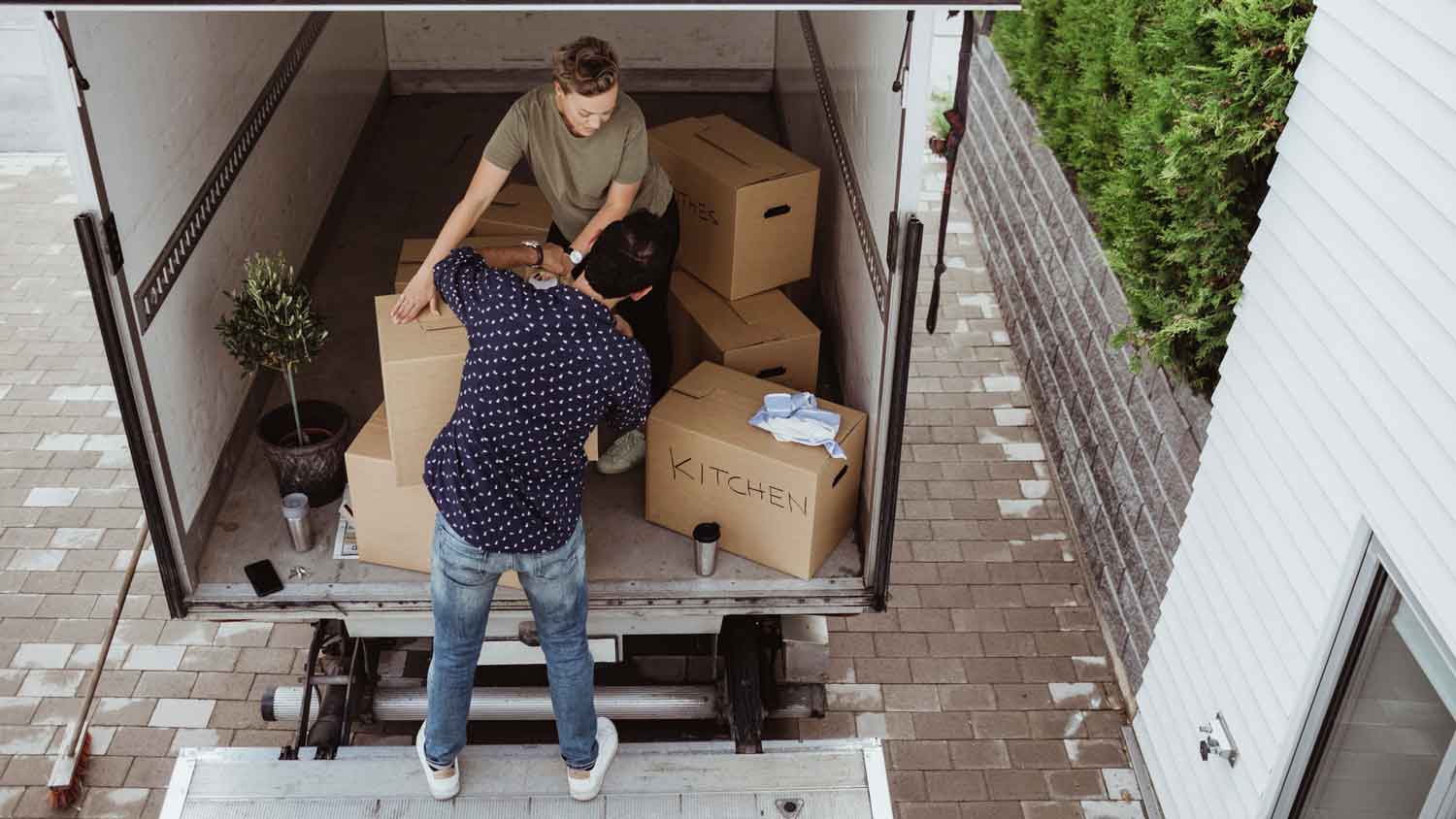 A couple loading a truck with boxes