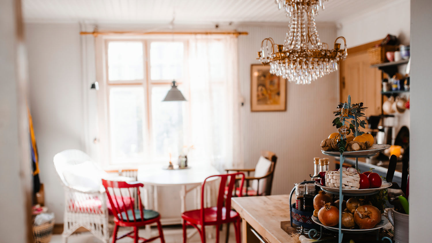 A cozy kitchen with a chandelier in the background