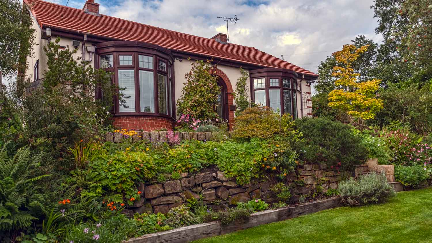 The exterior of a house with two bow windows