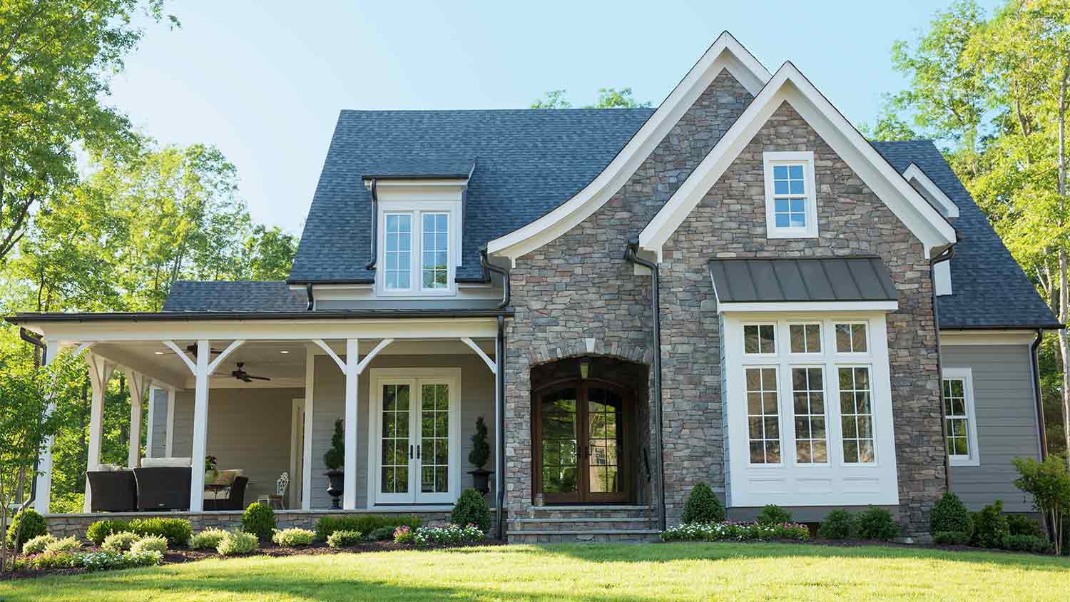 A view of the exterior of a house with a bay window
