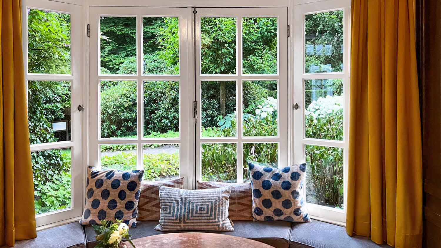 A marble coffee table in front of a bow window