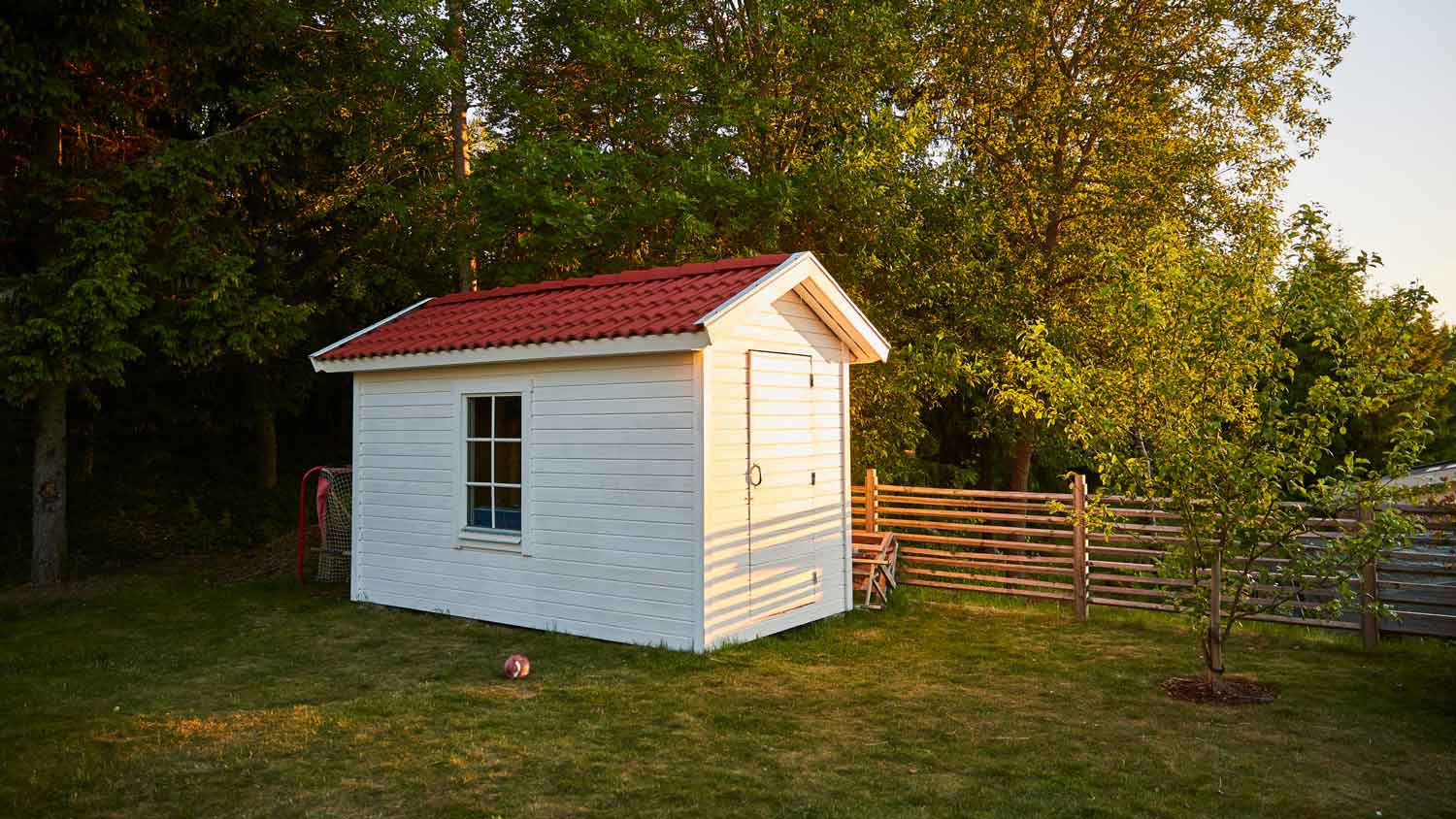 A wooden shed in a backyard