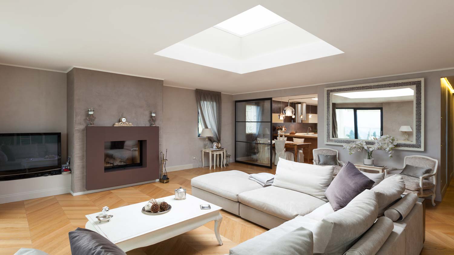 A beautiful living room with a skylight above the sofa