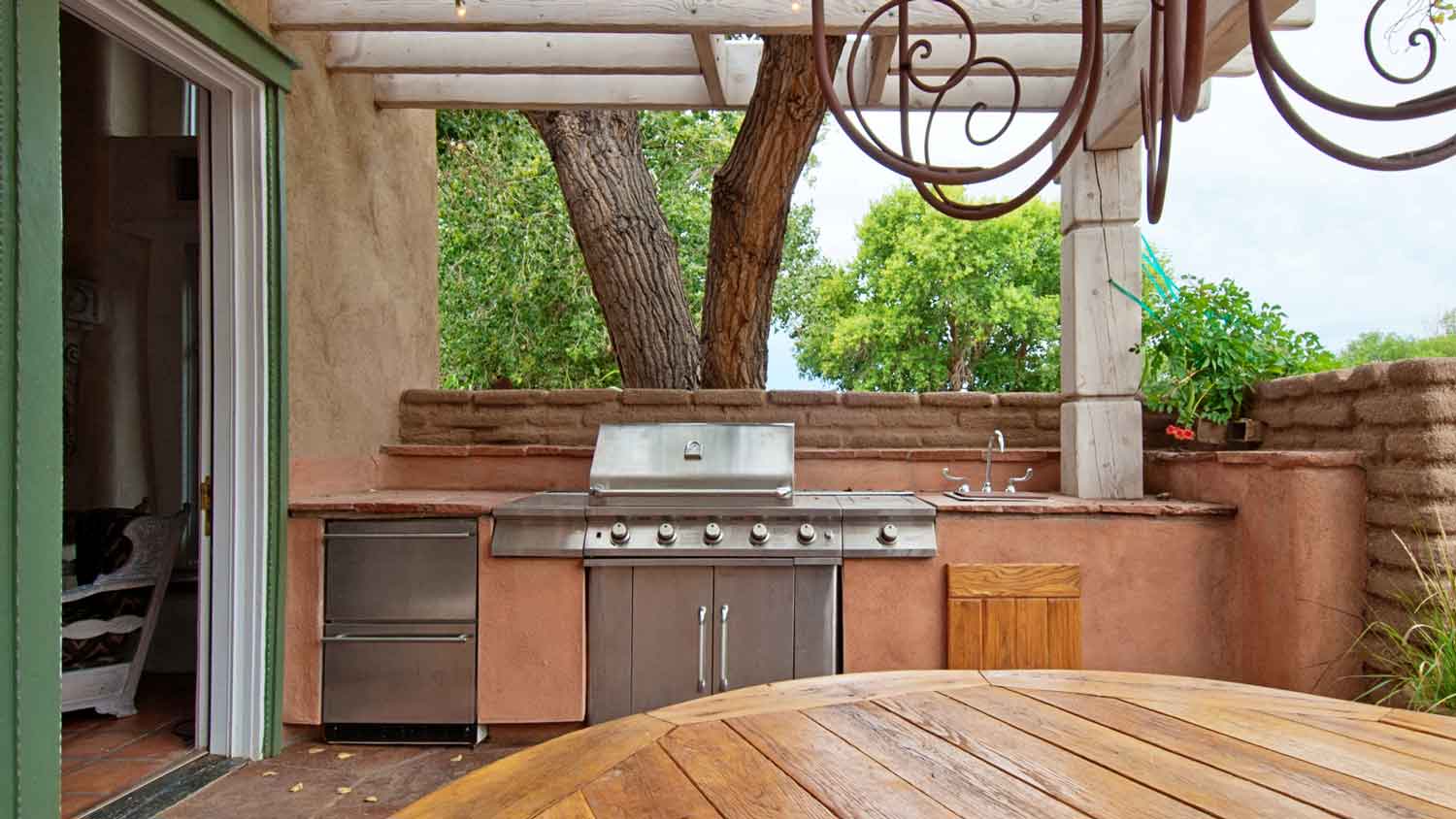 A linear outdoor kitchen with a gas grill