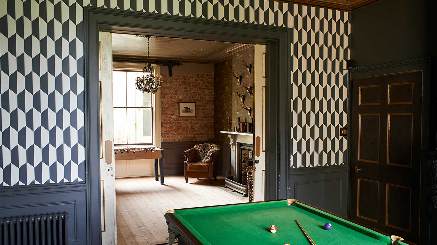 A view of a room with black trim and wallpaper