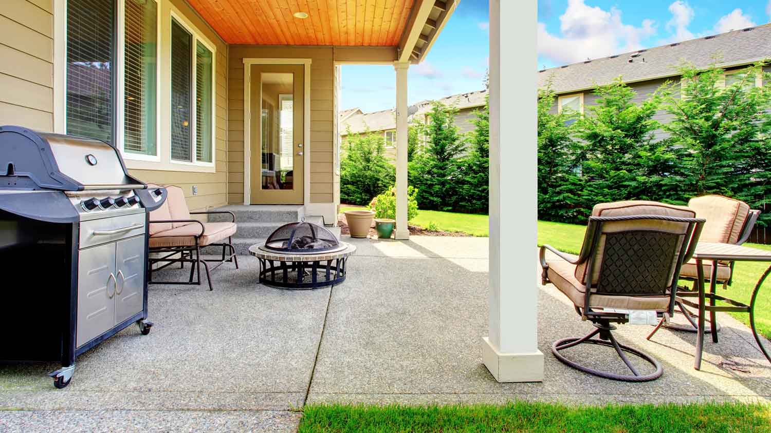 Concrete patio with grill and outdoor furniture