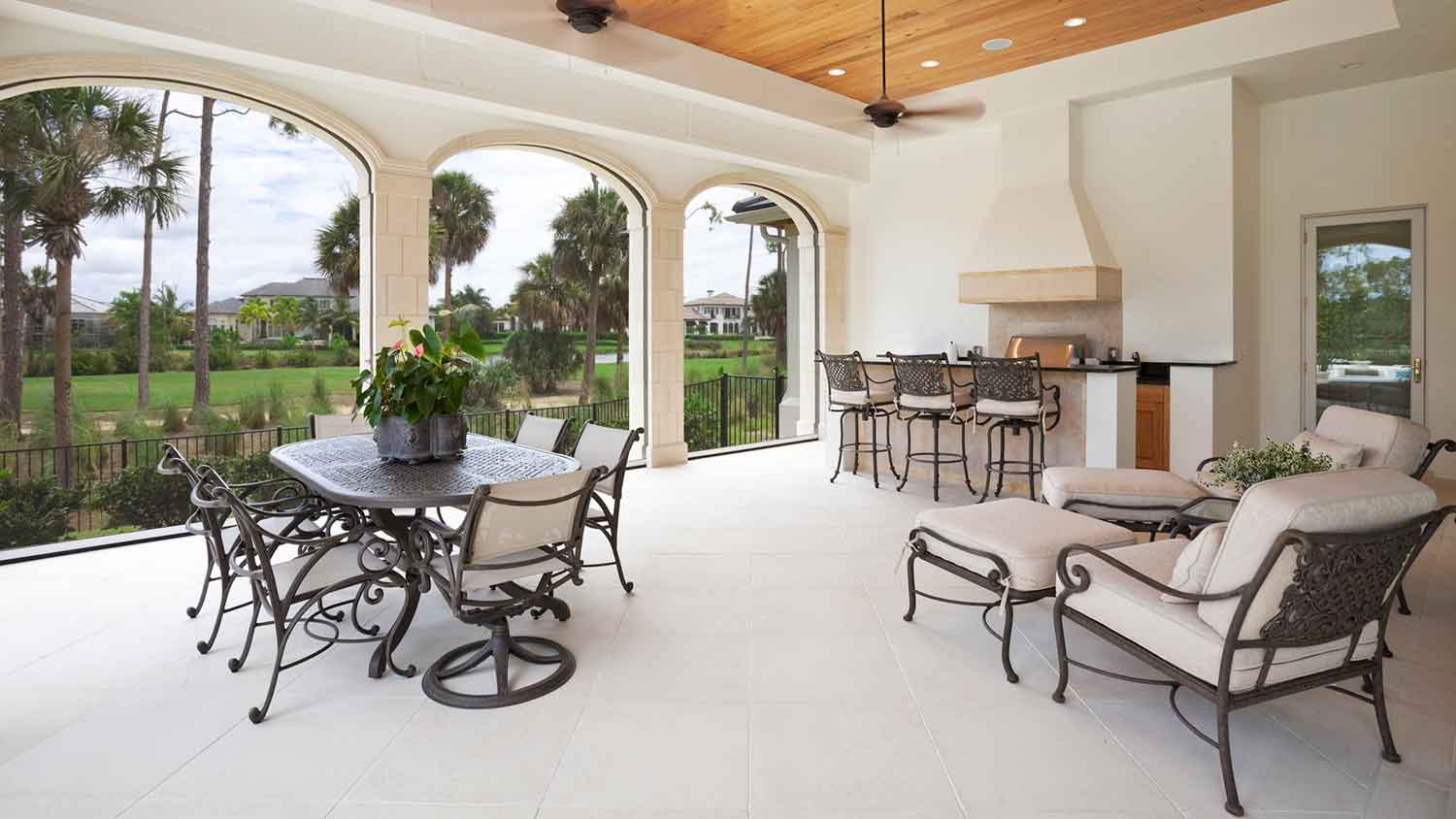 Luxury outdoor kitchen with tile flooring and dining table