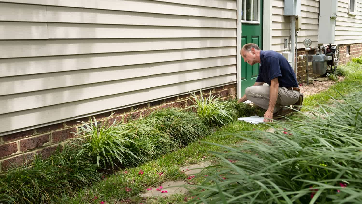 Man examining brick foundation