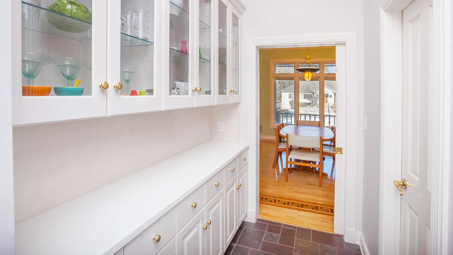 Walk in pantry with white cabinets