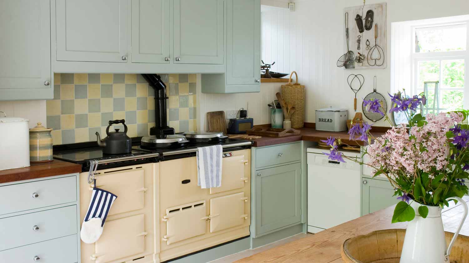 A kitchen with pastel colored cabinets