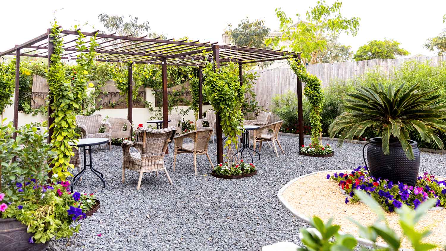 Outdoor sitting area with gravel and pergola