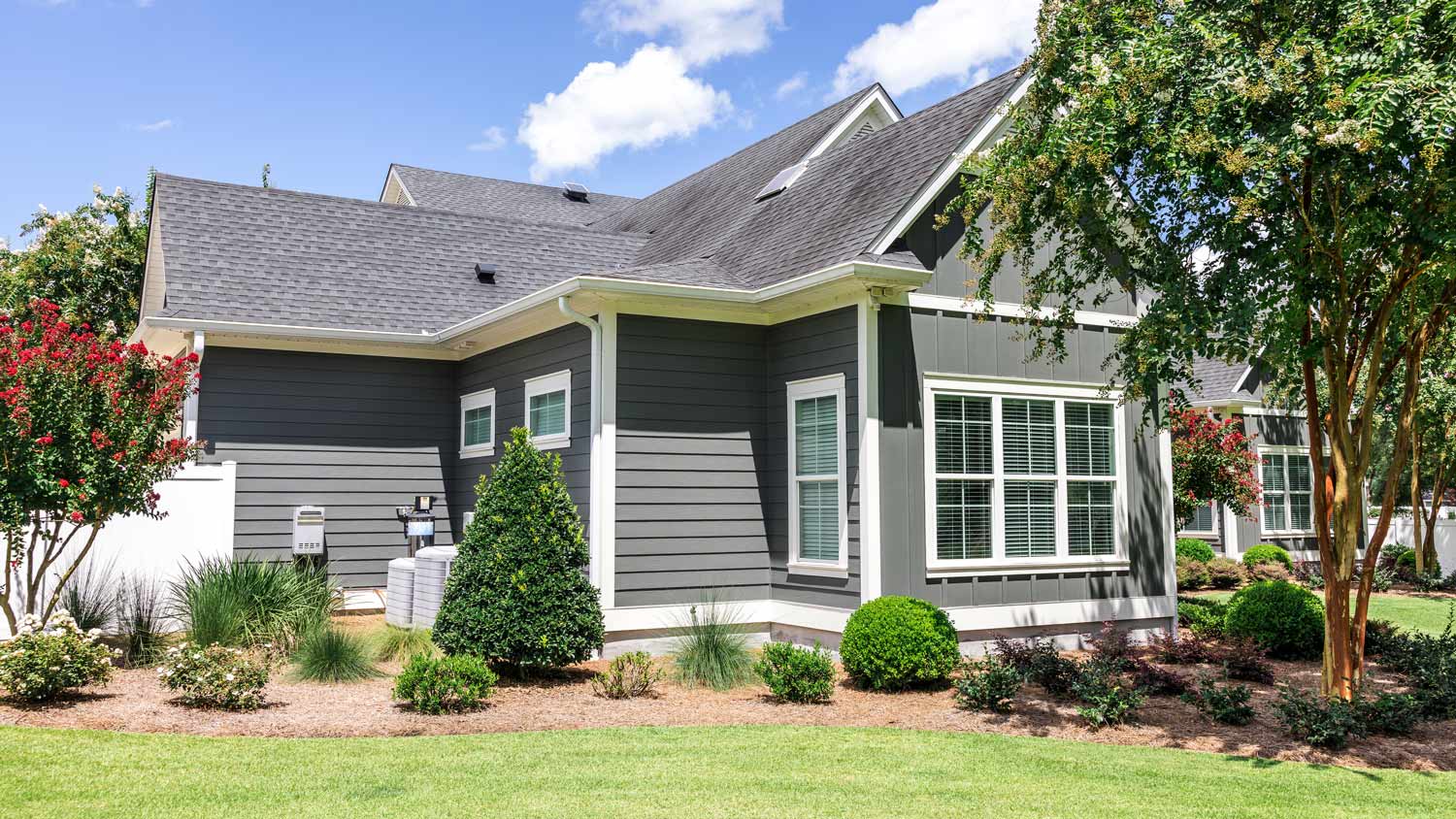 Side view of a large gray craftsman new construction house