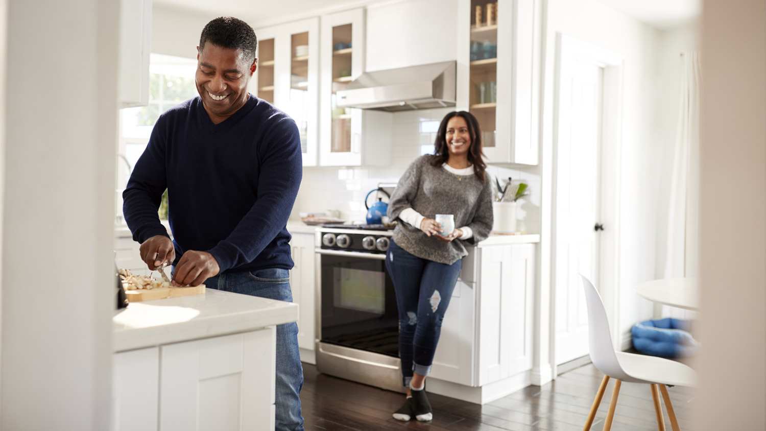 A couple spending time in kitchen while man is preparing dinner