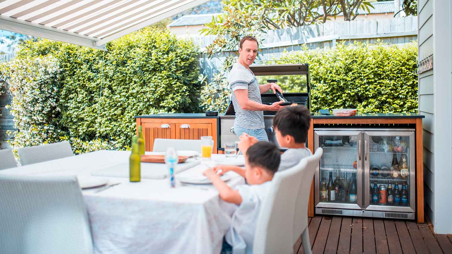 Father cooking a meal in the summer kitchen
