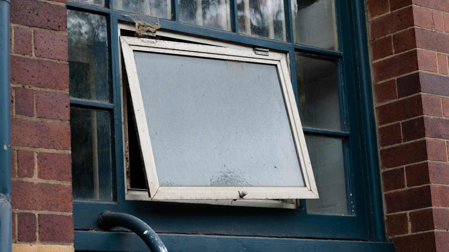 old hinged windows in brick home