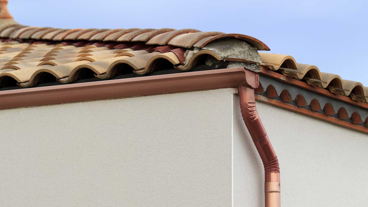 Copper gutters on a roof with shingles