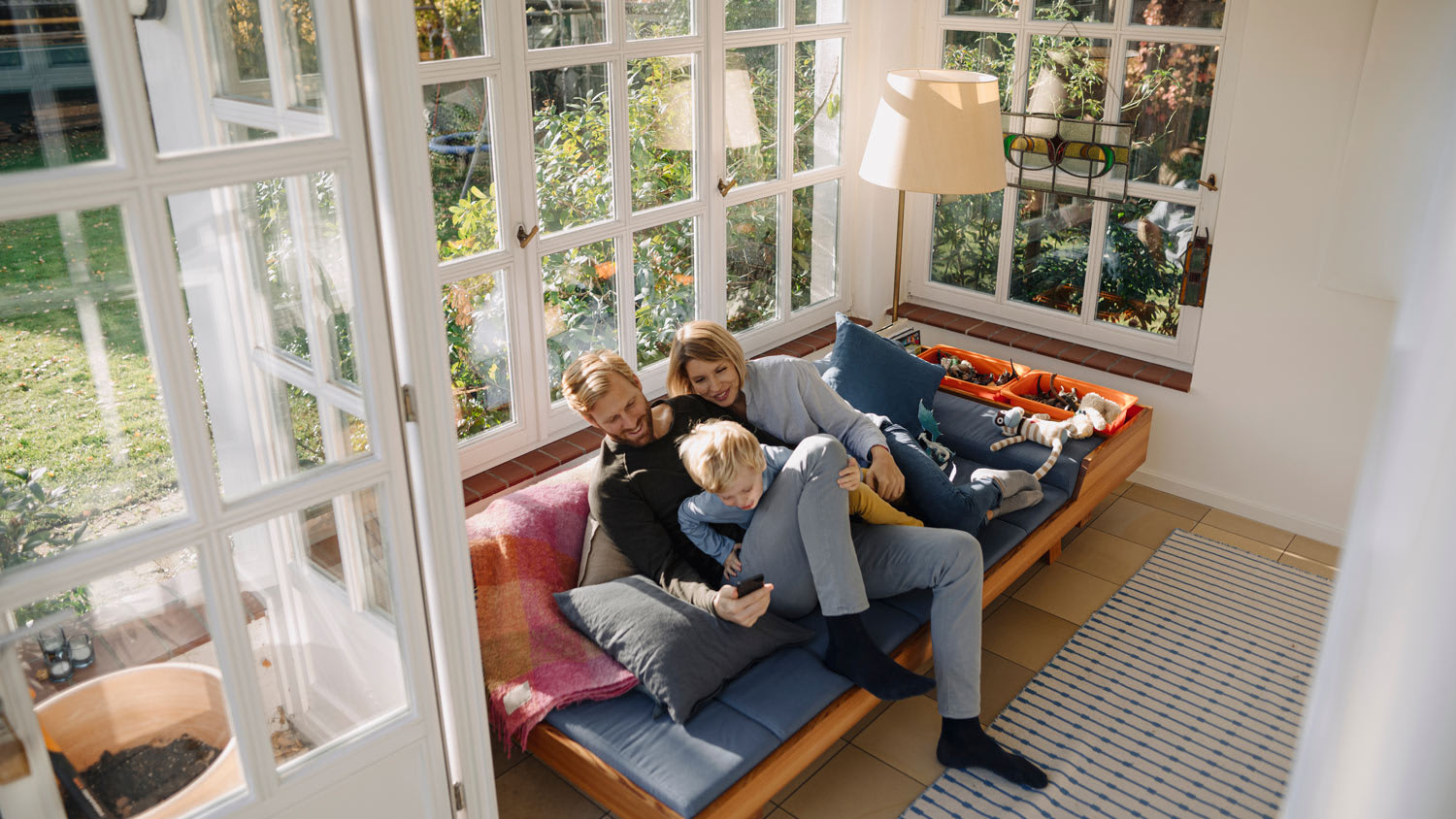 Family sitting on couch in sunroom