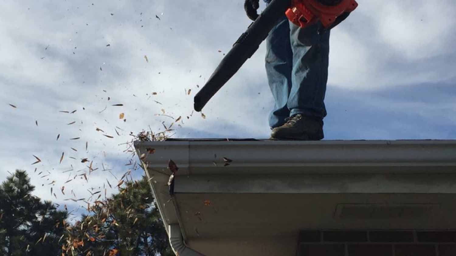 Blowing out leaves out of the gutters
