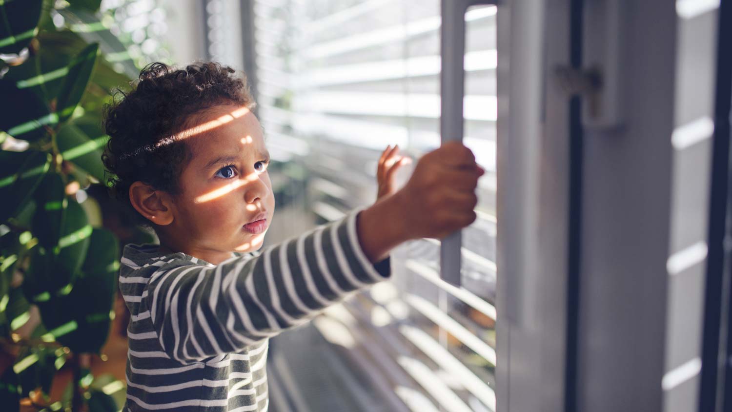 A kid opening a sliding window