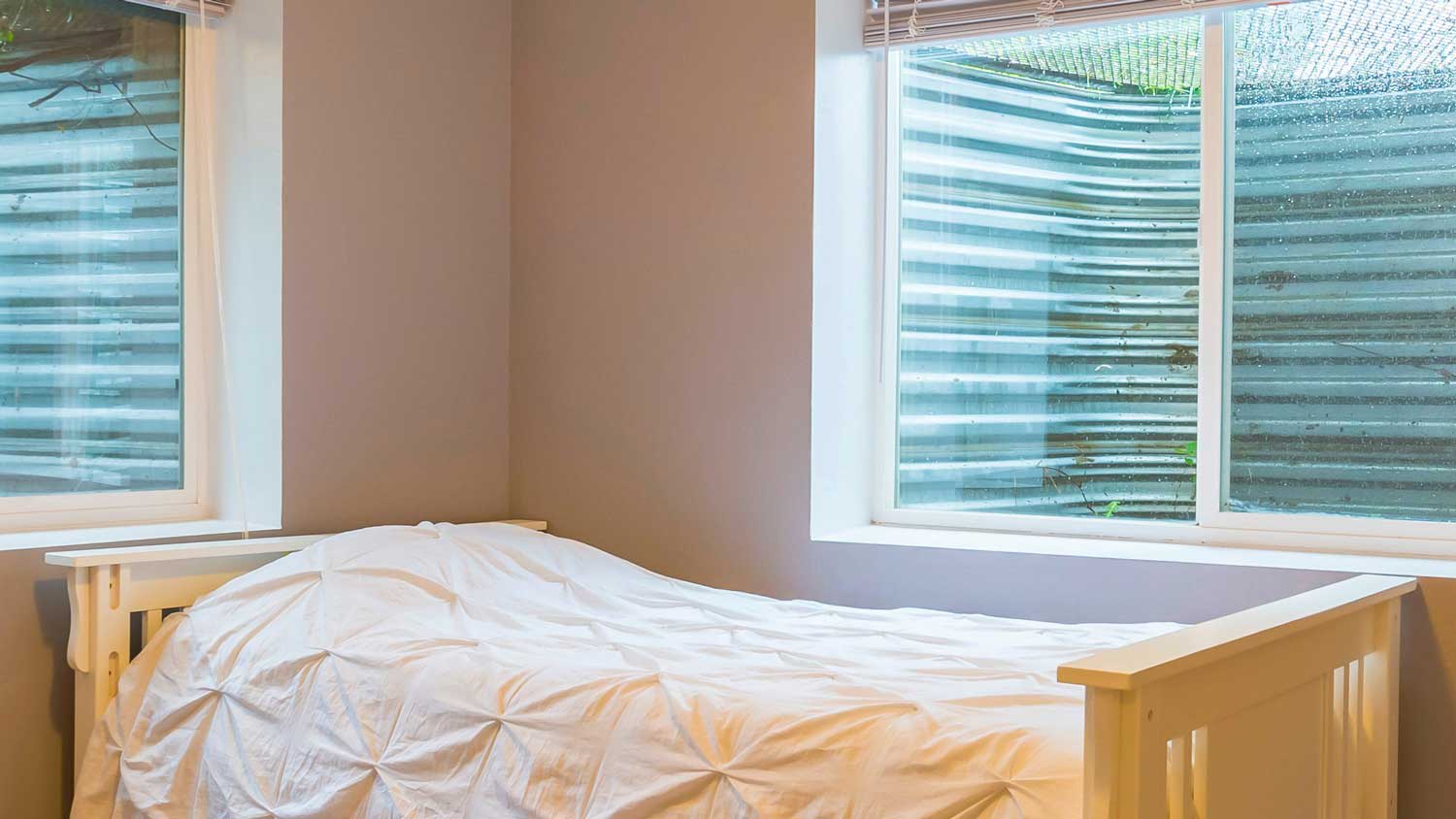 A single bed next to an egress window