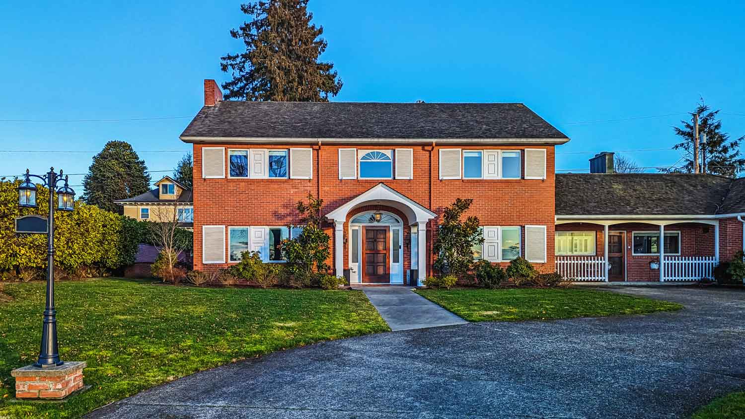 The exterior of a red brick house on sunrise