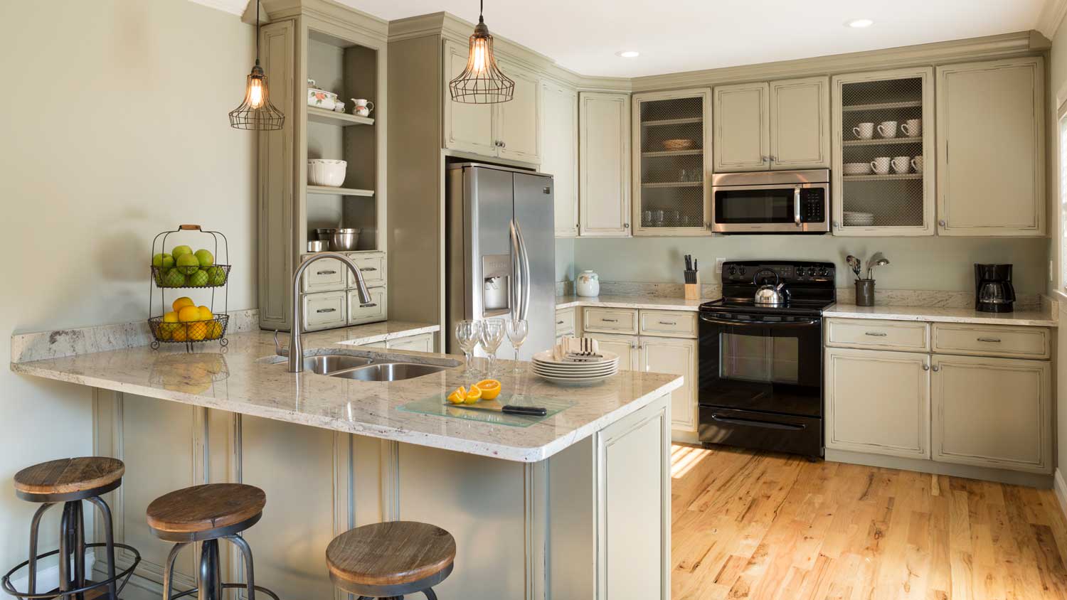 A kitchen peninsula with wood flooring