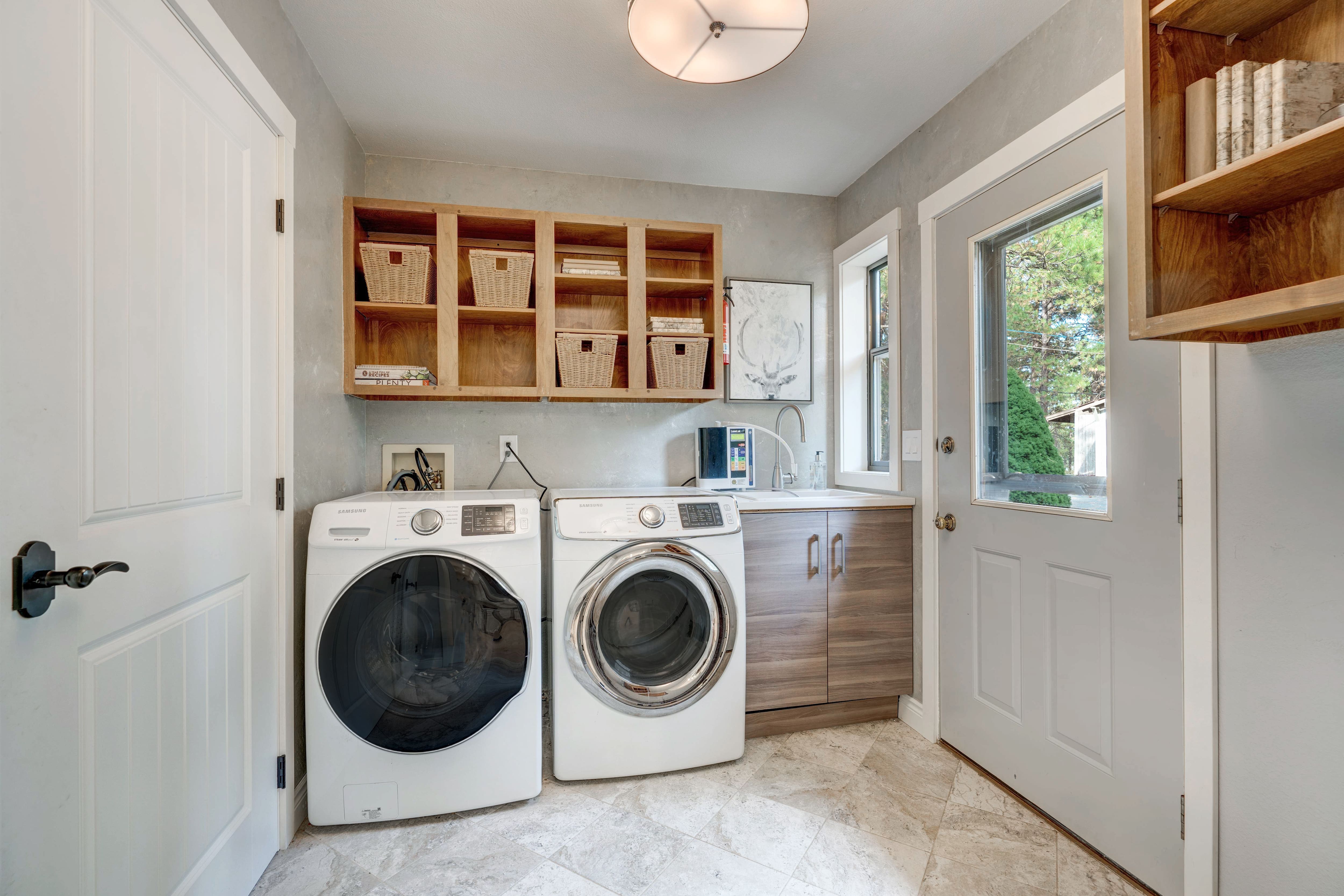A bright mudroom with a washer and dryer unit