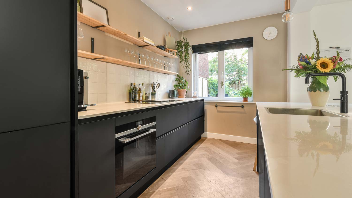A modern galley kitchen facing a window