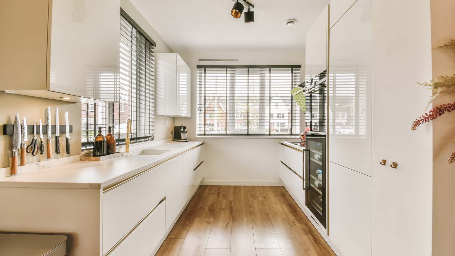 A galley kitchen with wood flooring