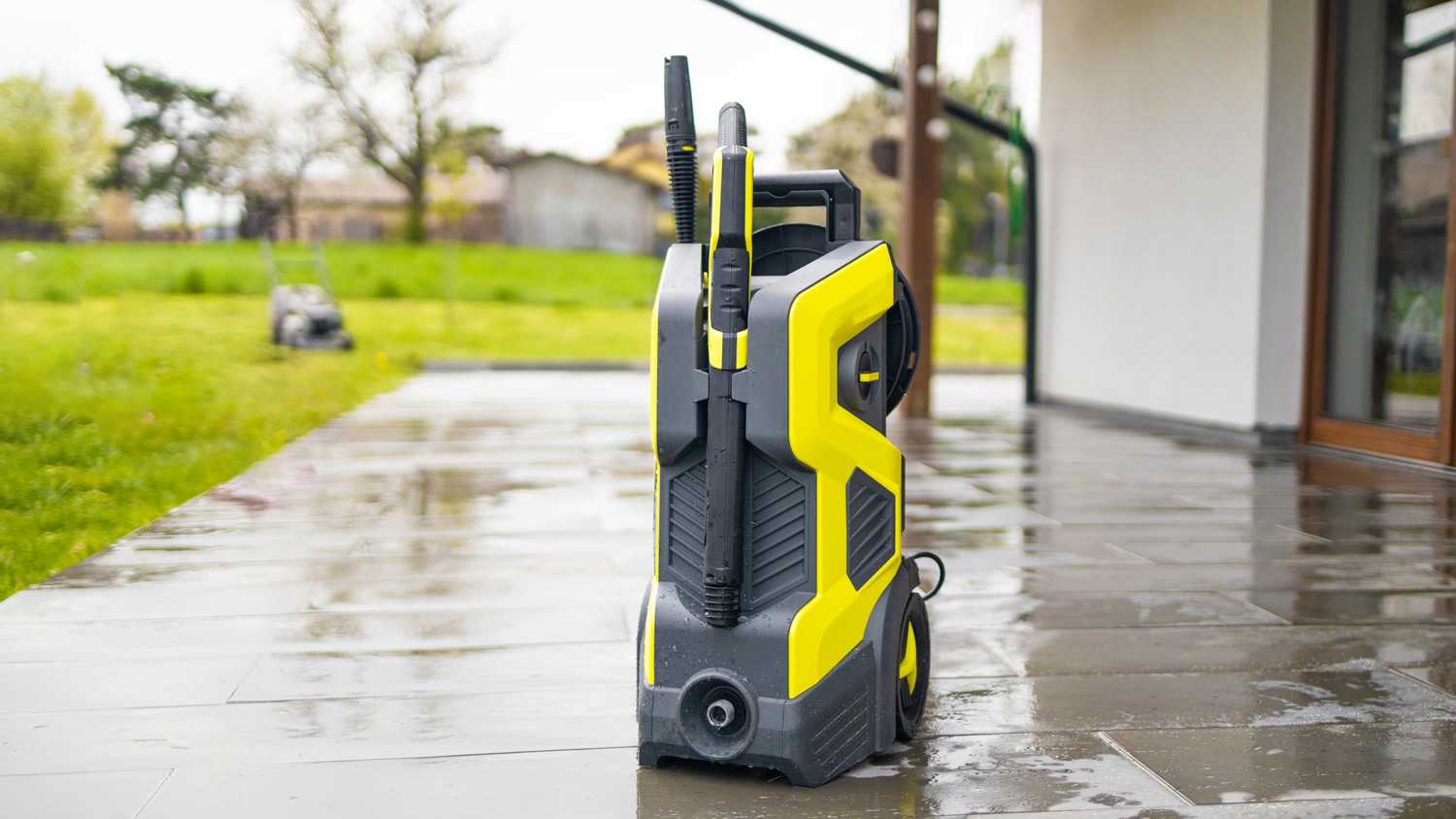 Pressure washer cleaning machine on wet concrete