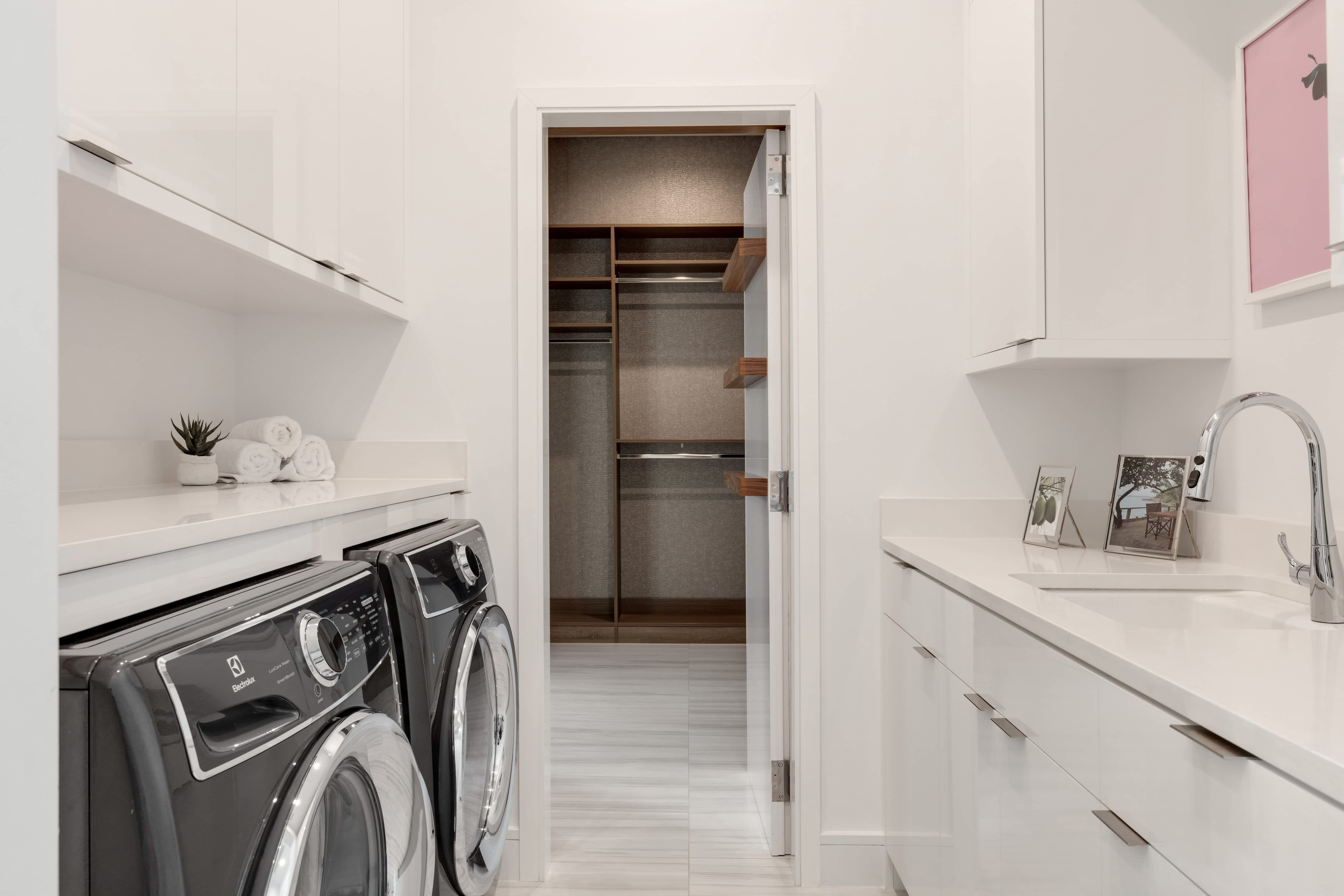 A mudroom with laundry units and a walk-in closet