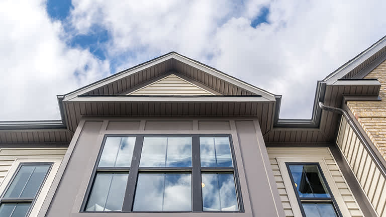 Clouds reflect in striking black vinyl windows