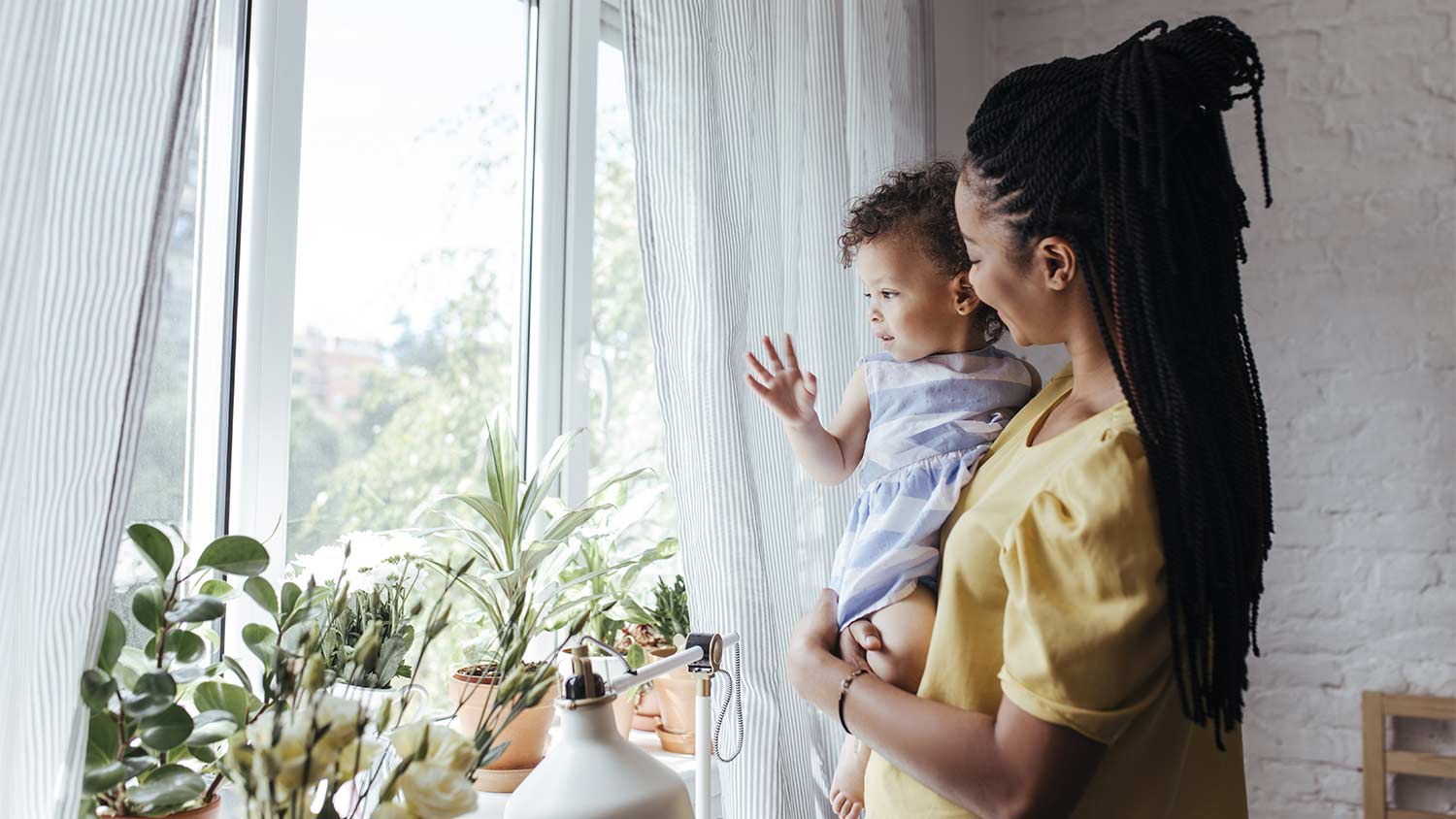 woman and child standing by the window