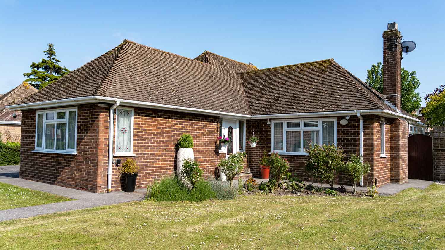 Small one-story brick house with white gutters