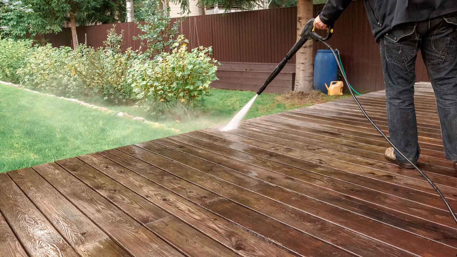 A man power washing a patio