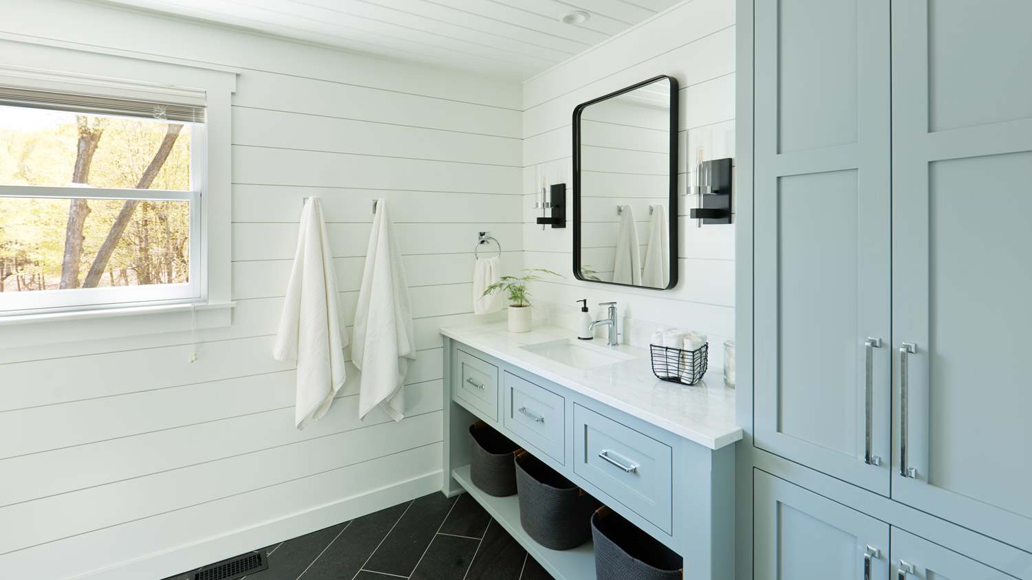 A country style bathroom with wooden cabinet