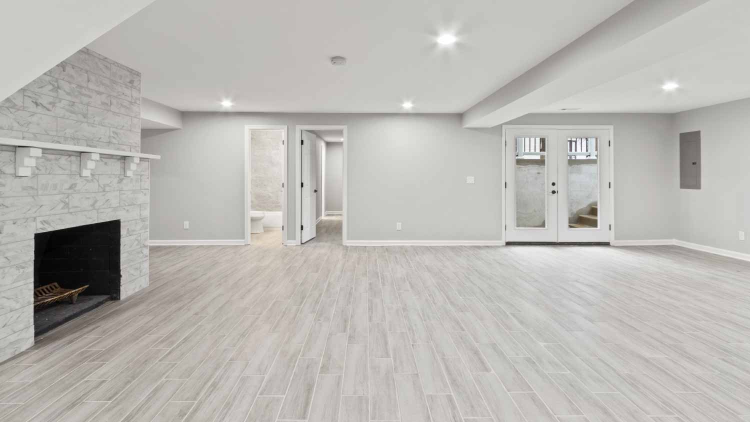 Empty basement room with fireplace