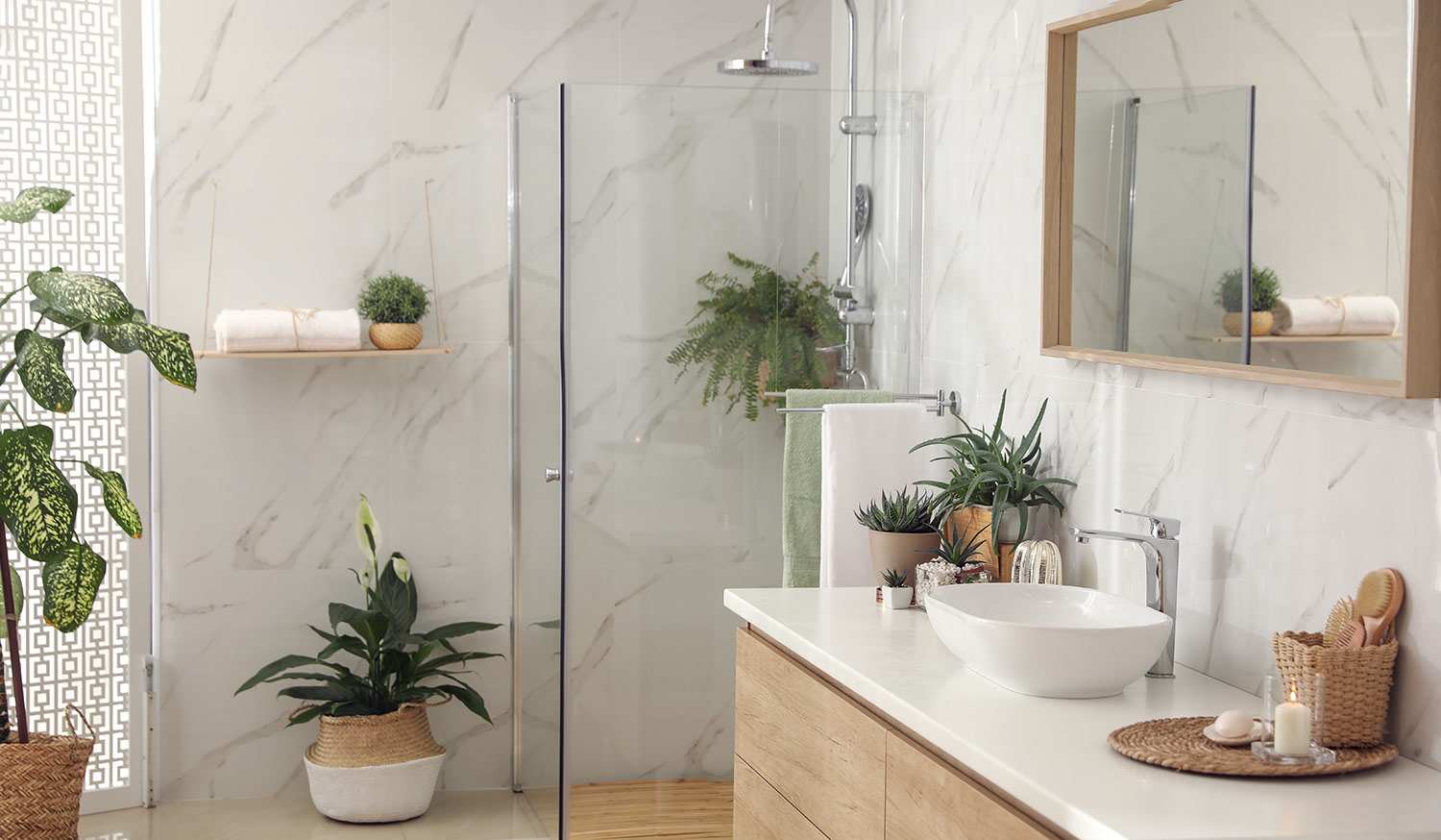 Stylish bathroom interior with countertop, shower stall and houseplants
