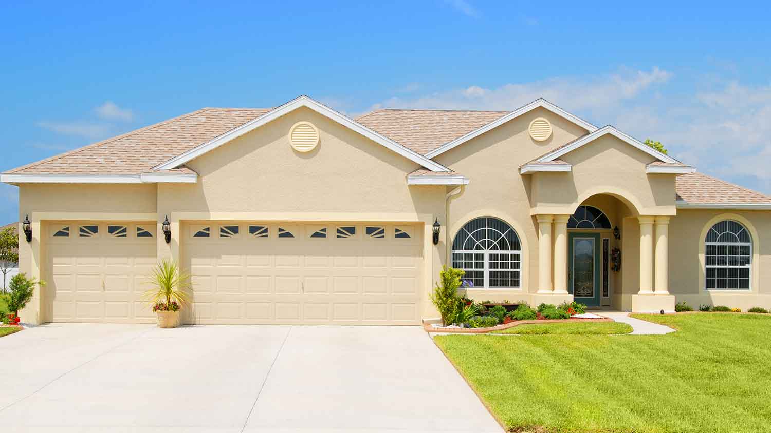 Exterior of a beige house with stucco siding