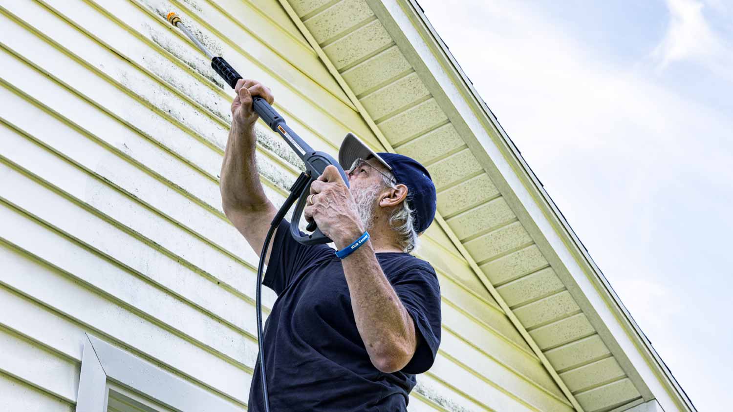 Man washing house siding