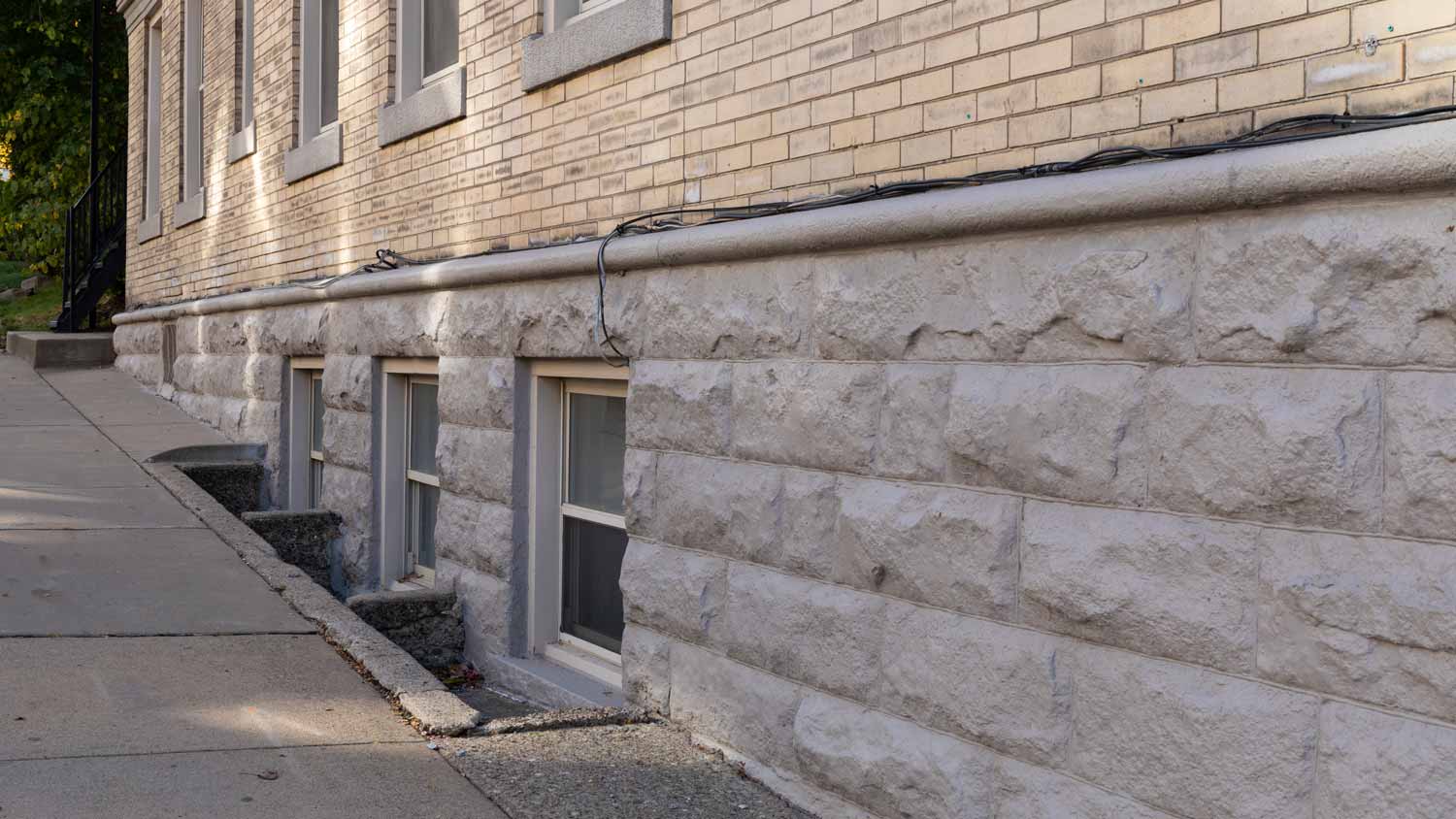 A window well in a stone and brick house