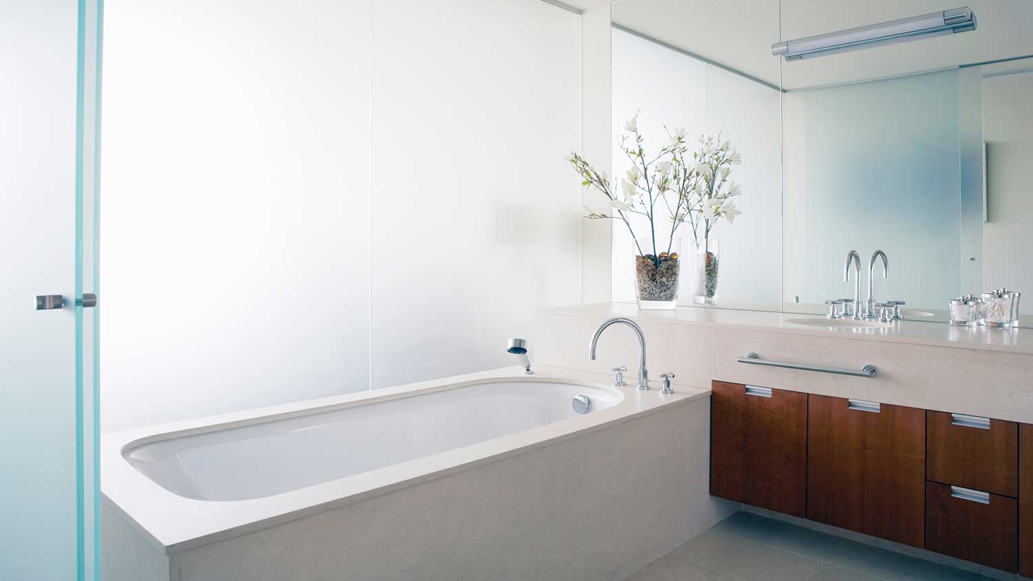 Modern bathroom with acrylic bathtub and glass walls