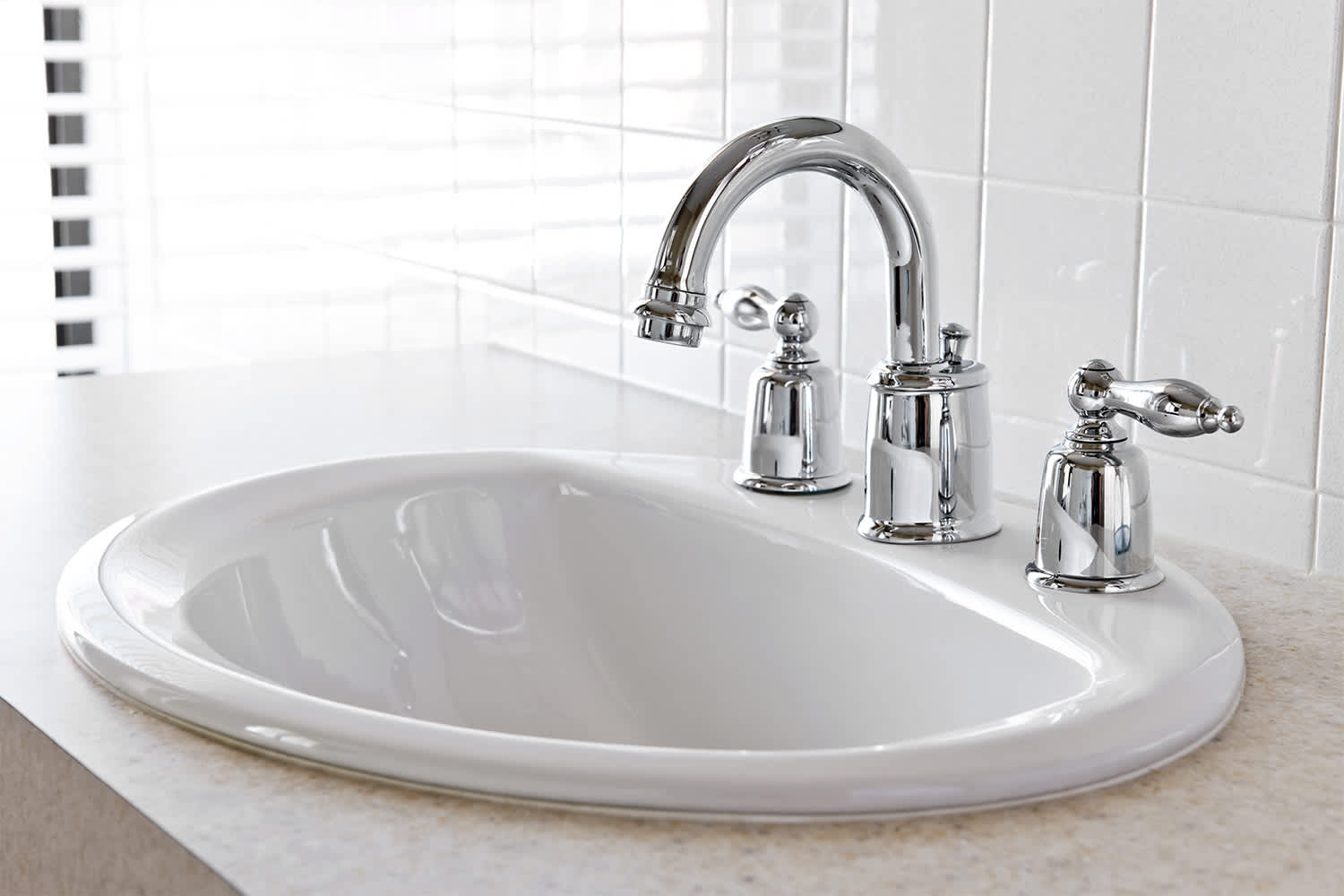 White drop - in bathroom sink